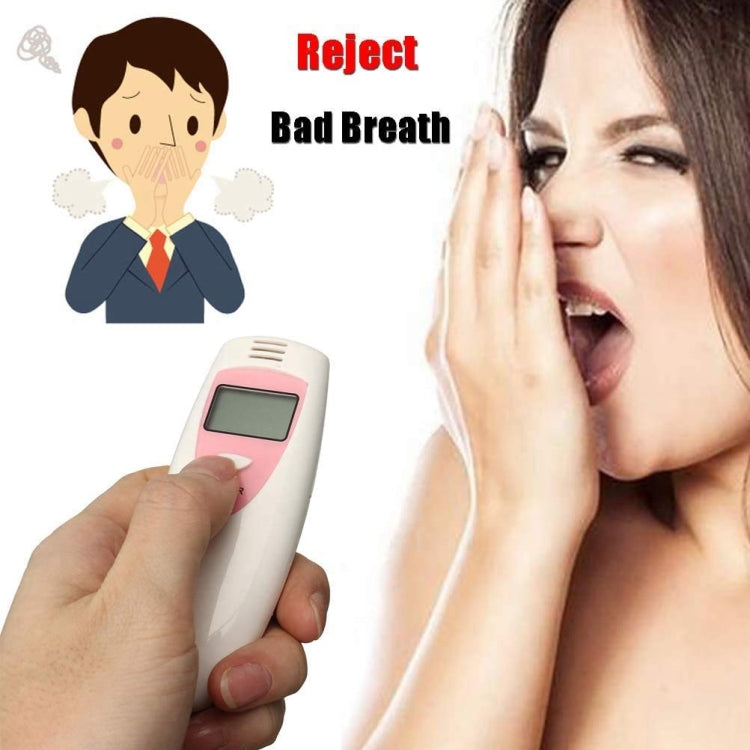 Bad breath detector held near open mouth, white and pink handheld with LCD