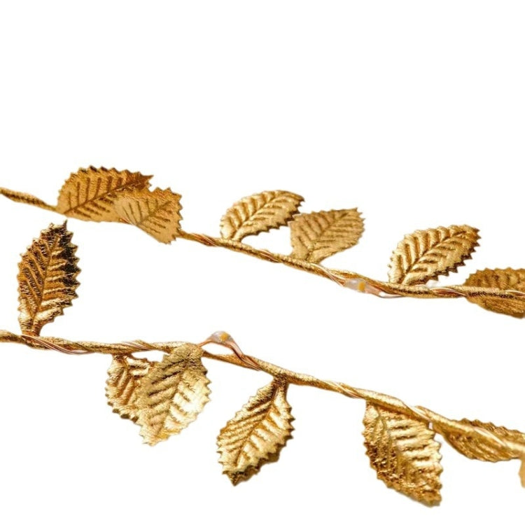 Gold artificial leaf vine light string with textured leaf details along the wire