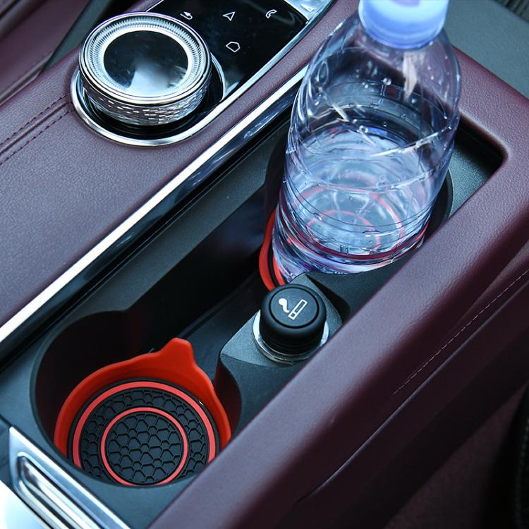 Red silicone water coaster with black double-ring and textured center, non-slip base