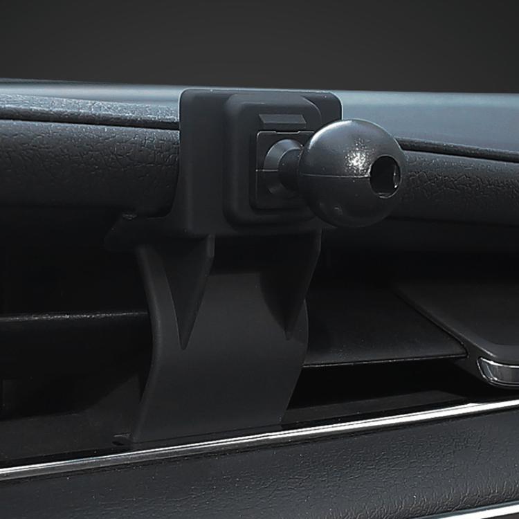 Black dash phone mount base with ball joint on vent/outlet area, close-up
