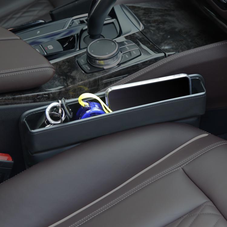 Car seat gap storage box tray holding small items in car interior