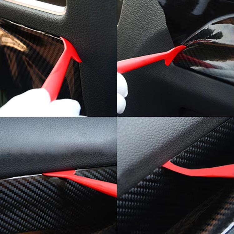 Red edge trimmer tool pressing car film into a textured dash seam