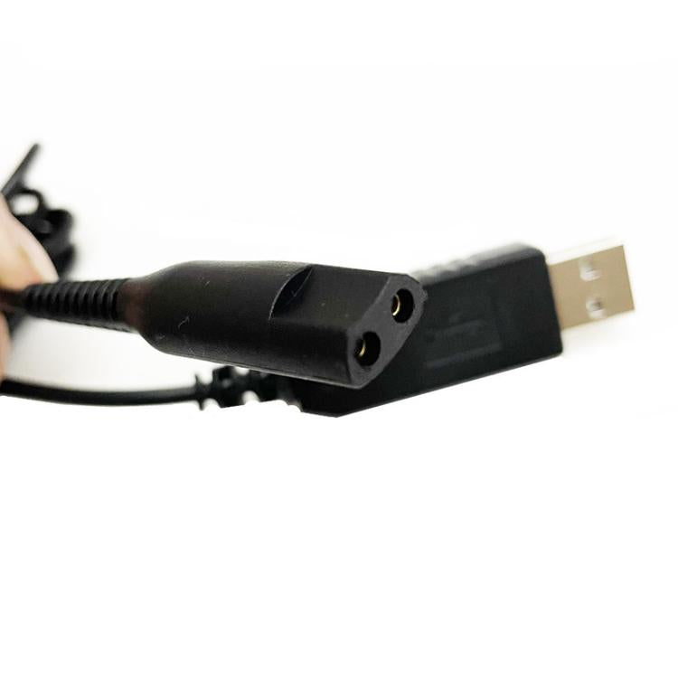Close-up of black USB charging cable end with two-pin connector