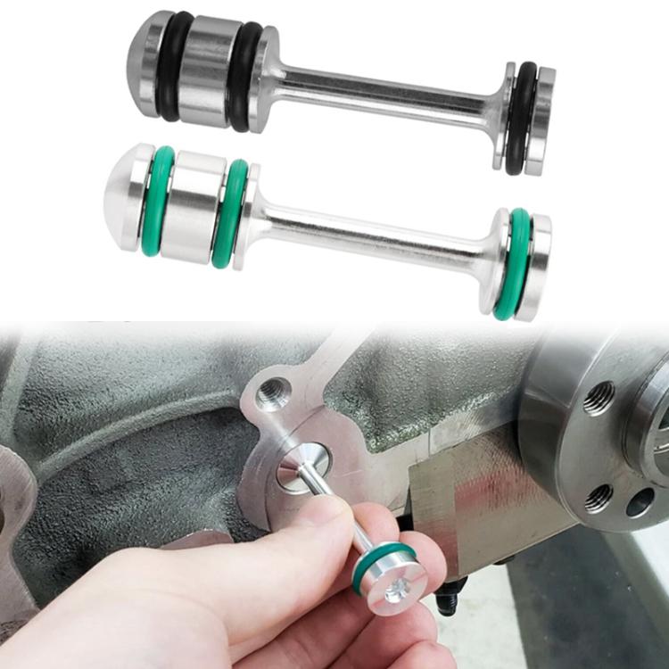 Aluminum oil steering barbell with green bushings, shown held for installation