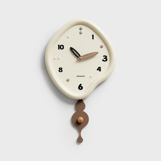 Beige irregular pendulum wall clock with off-white dial and bronze-brown pendulum