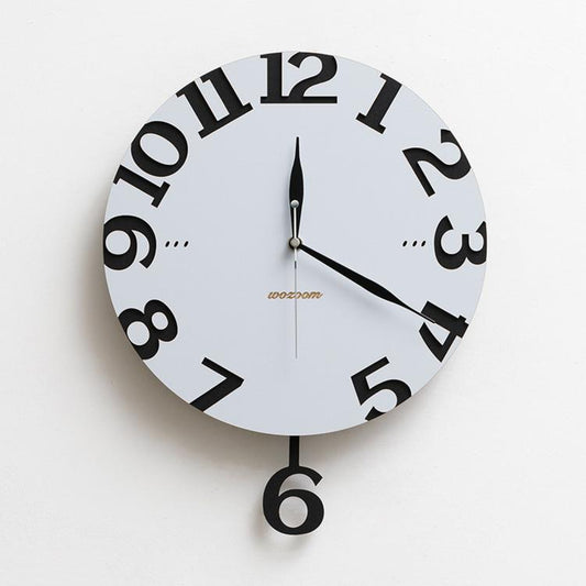 Modern wall clock with cream face, black numerals, black and silver hands, and hanging 6