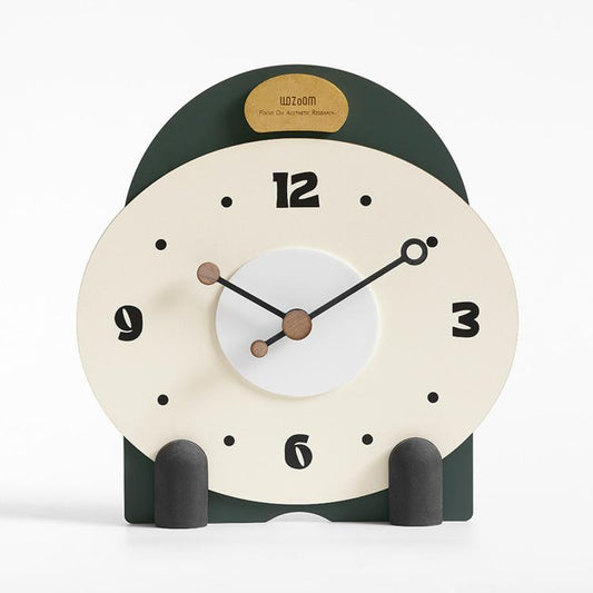 Small mantel table clock with cream dial, dark green top, and gray side pegs