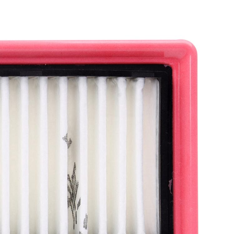 Cabin air filter corner close-up with white pleats and red rubber trim