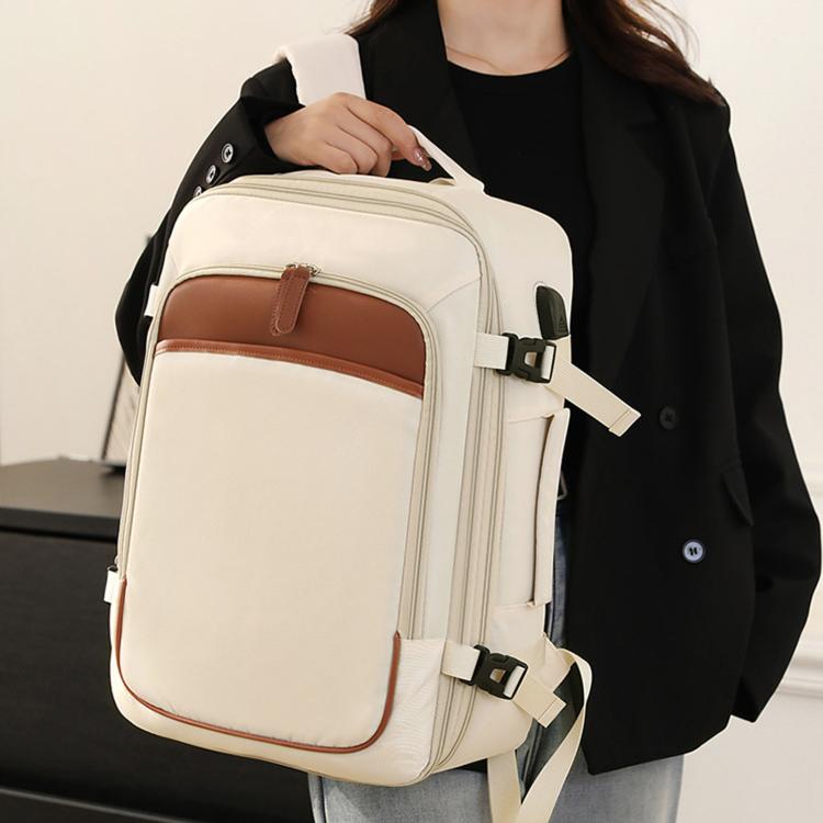 White travel backpack worn on front with adjustable shoulder and chest straps