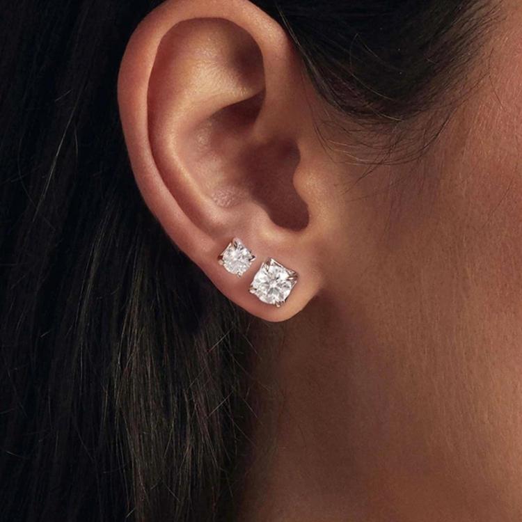 Square moissanite stud earrings in sterling silver, worn on ear