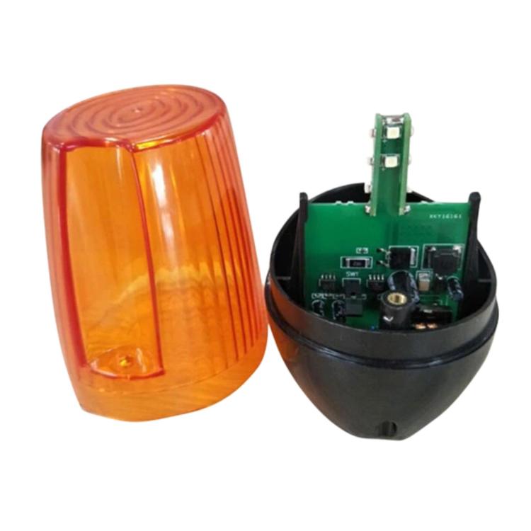 Amber strobe light with orange lens and interior electronics on black housing