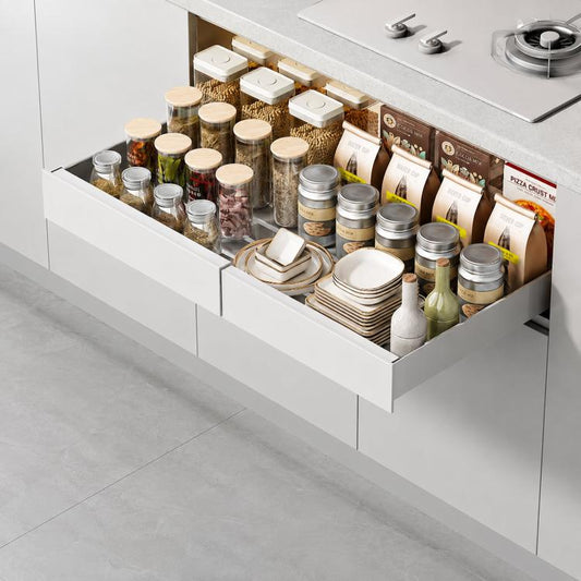 White under-sink pull-out cabinet organizer drawer with raised edge and spice jars shown inside