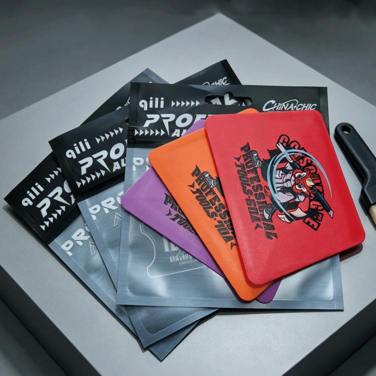 Stack of assorted double-sided wrapping film scraper pads in multiple colors