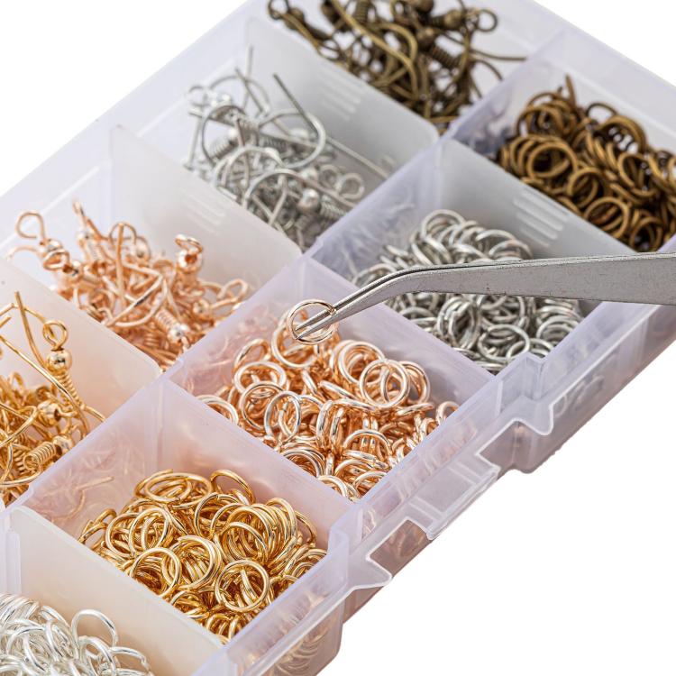 Close-up of clear organizer compartments filled with gold, silver, and bronze jump rings
