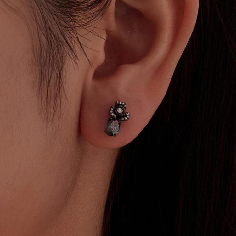 Black zircon drop earrings on ear, faceted teardrop and floral stone cluster