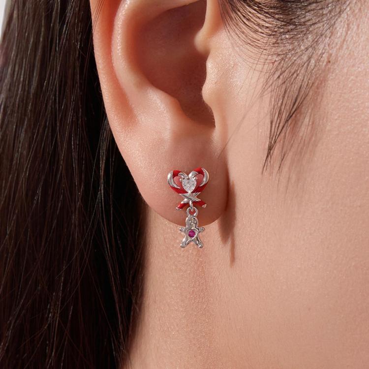 Sterling silver candy-cane heart stud earrings with dangling gingerbread charm on wearer