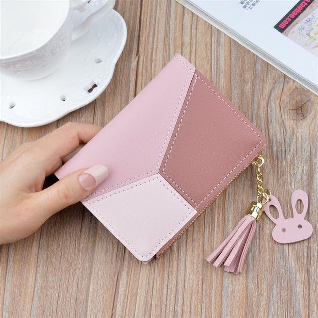 Light pink panelled leather wallet with tassel keychain and gold chain detail