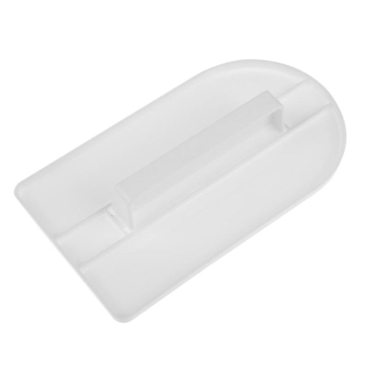 White silicone cake smoother tool, angled view with raised grip and center line