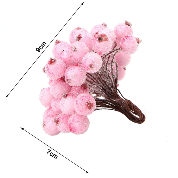 Pink foam berry bunch with round fuzzy berries on brown twig stem