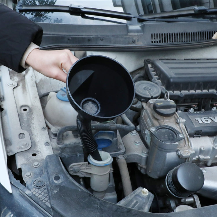 Plastic funnel placed in engine bay fill port, ribbed spout, black