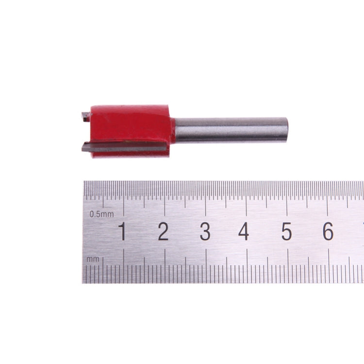 Red router bit on silver shaft with size scale for measurement