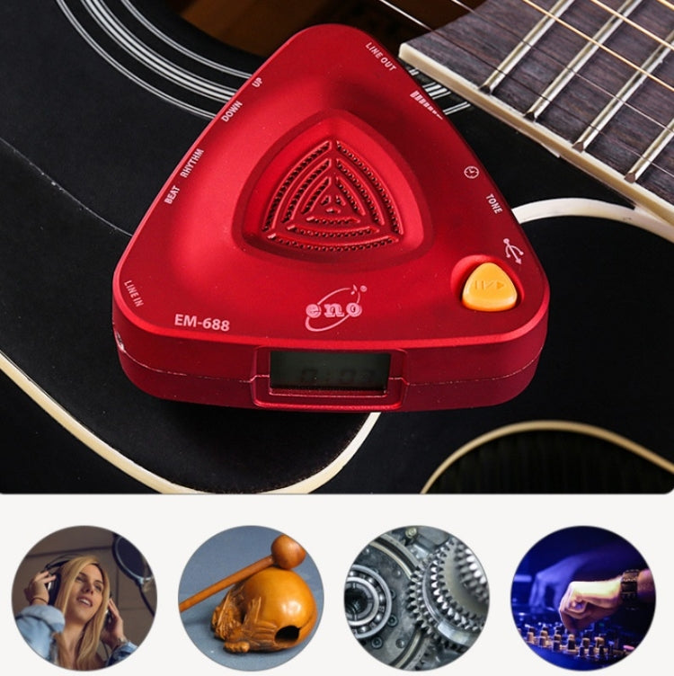 Red electronic metronome with side USB port near a string instrument