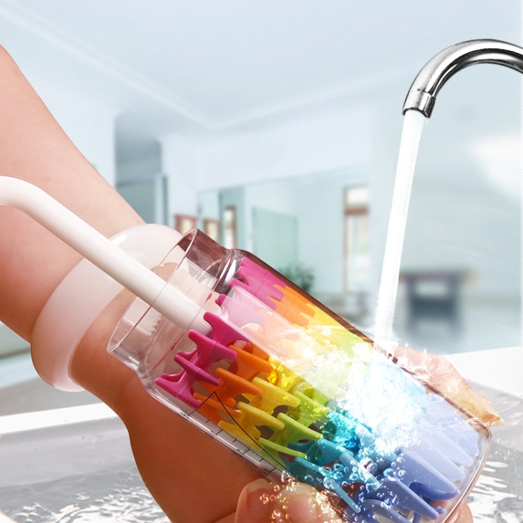Silicone baby bottle brush cleaning a small bottle with colorful bristles