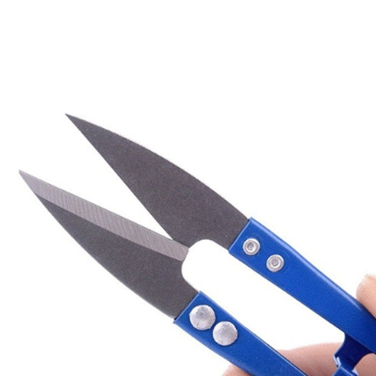 Blue mini embroidery scissors held in hand, stainless steel pointed blades with screws