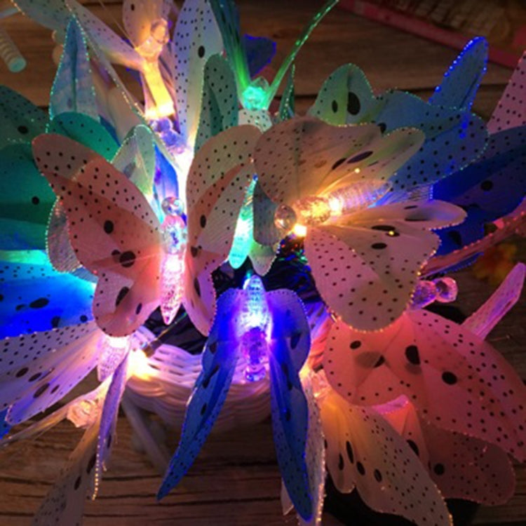 Close-up of multicolored glowing butterfly fairy lights with fiber optic stems