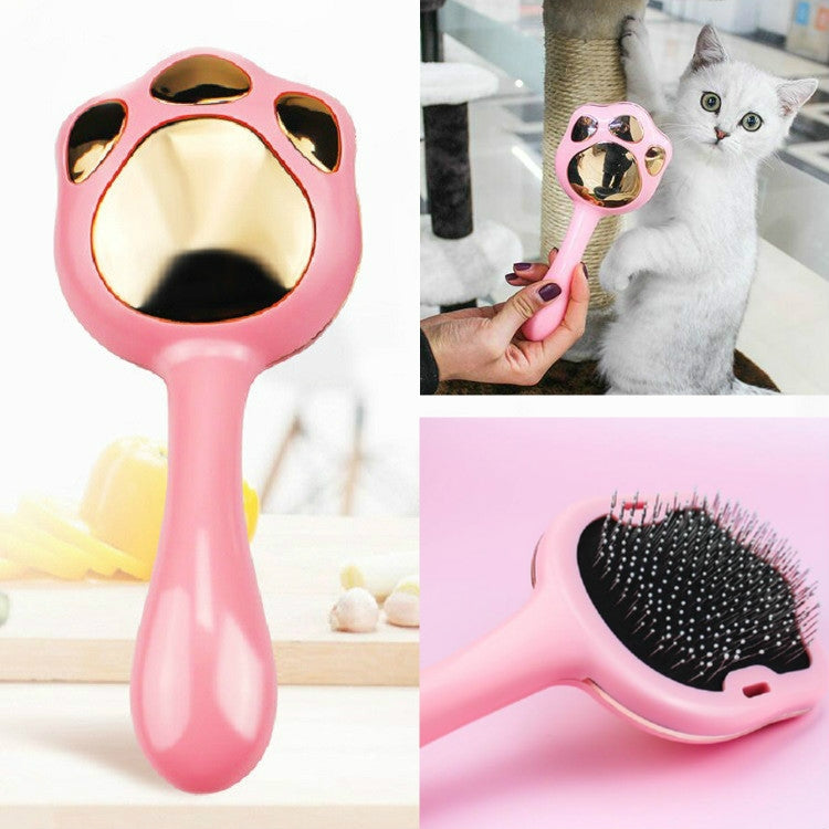 Pink pet hair removal brush shaped like a paw with black bristle pad