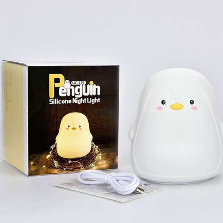 White penguin silicone night light with charging cable and box packaging.