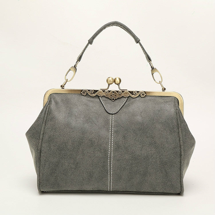 Dark gray retro handbag with top chain handles and gold-tone kiss-lock clasp.