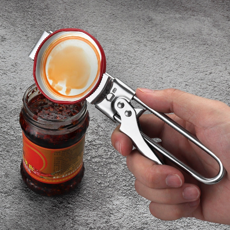 Hand holding stainless steel adjustable can opener over a jar lid