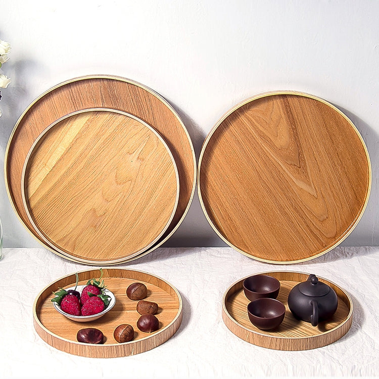 Set of round wooden trays with strawberries and small teapot cups