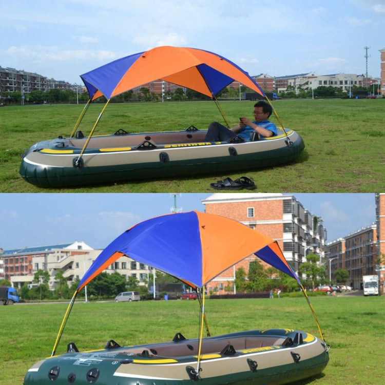 Canoe with attached orange and blue folding awning tent shelter over the seating area