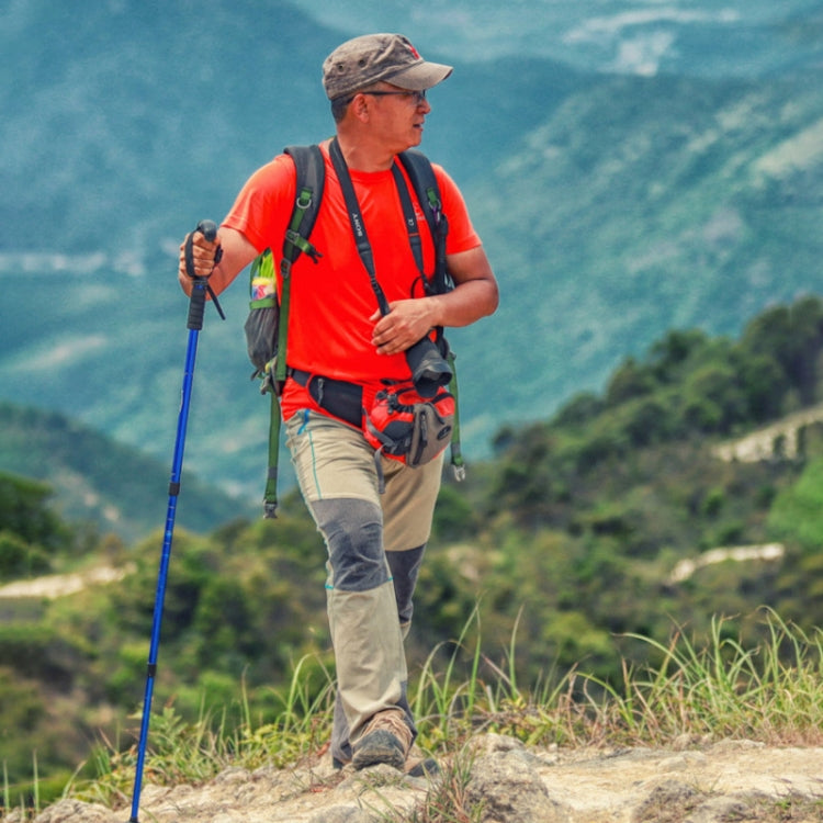 Telescopic trekking pole with blue shaft and black grip, shown while hiking