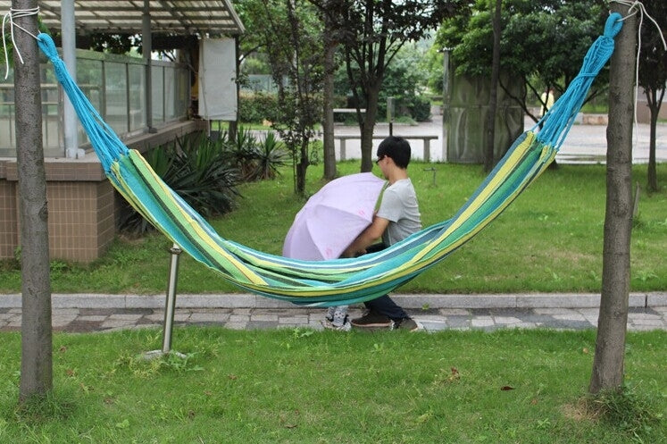 Blue and green striped hammock swing with wide woven fabric bed