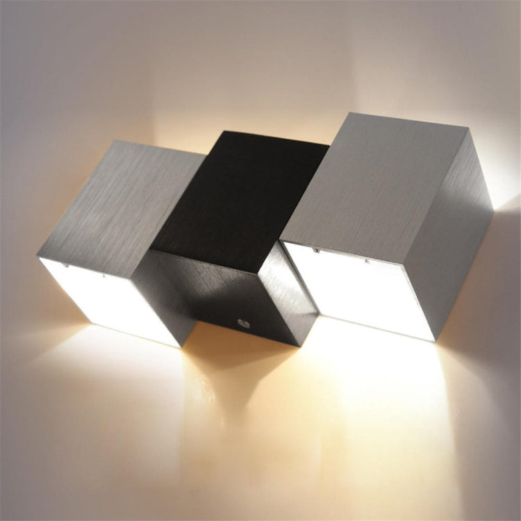 LED cube wall light with warm white glow from stepped blocks