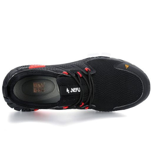 Black safety shoes with mesh upper, red lace eyelets, and cushioned insole opening