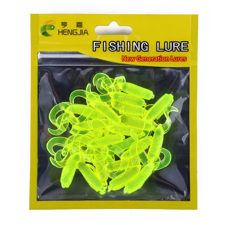Lime yellow double-tailed soft fishing lures in blister pack.