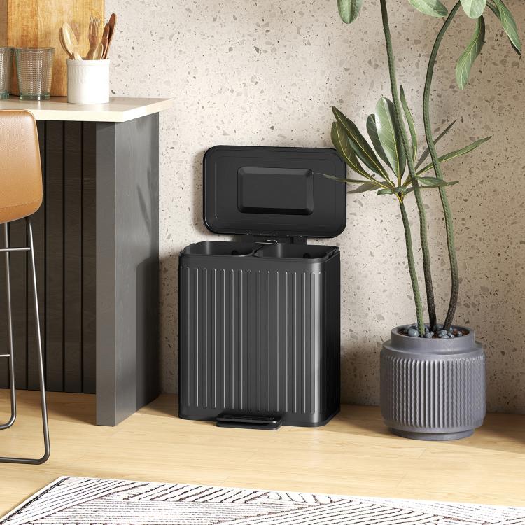 Black step-on kitchen trash can with hinged lid and ribbed body, pedal front