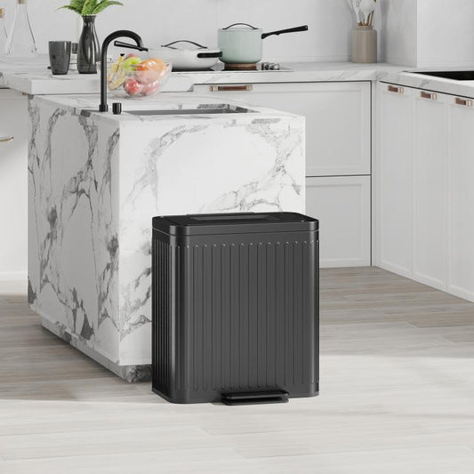 Black step-on trash can with lid and ribbed body, front pedal at base