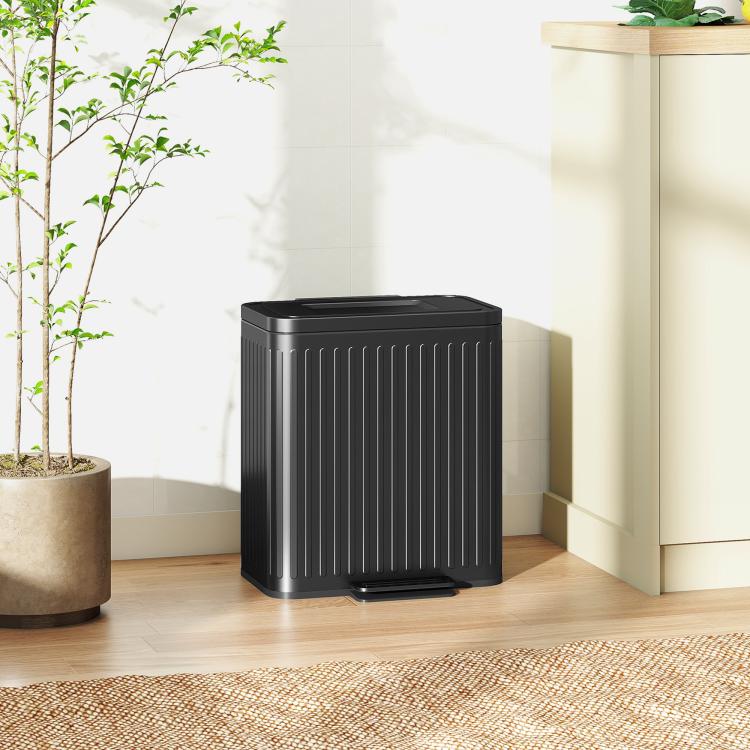Black step-on trash can with lid, ribbed body, and front pedal for hands-free use