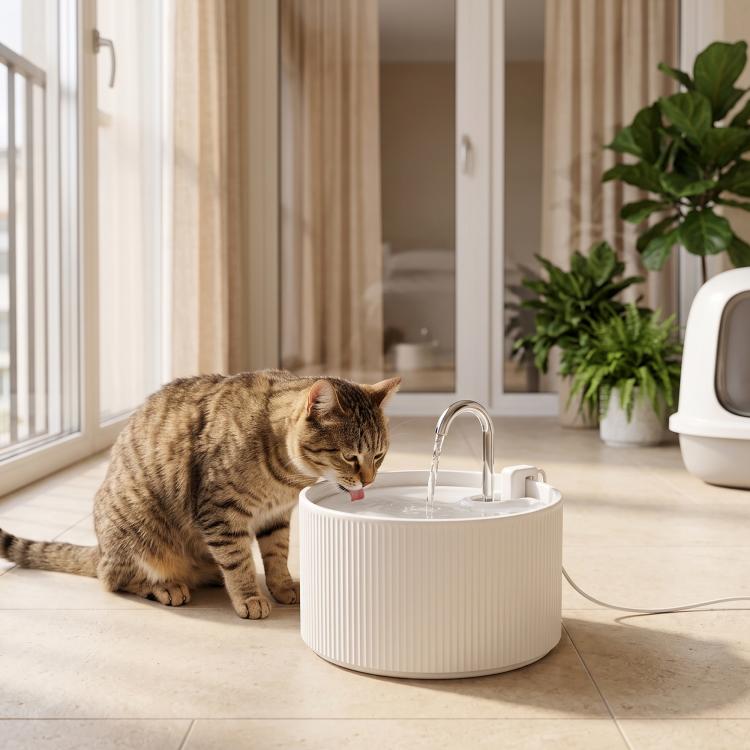 White ceramic pet water fountain with chrome faucet, tabby cat drinking