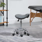Gray saddle stool on chrome base with five black caster wheels