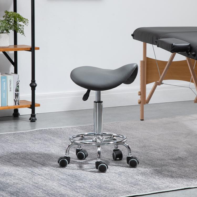 Gray saddle stool on chrome base with five black caster wheels