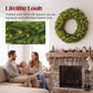 Pre-lit green Christmas wreath with warm LED lights above a stone fireplace.