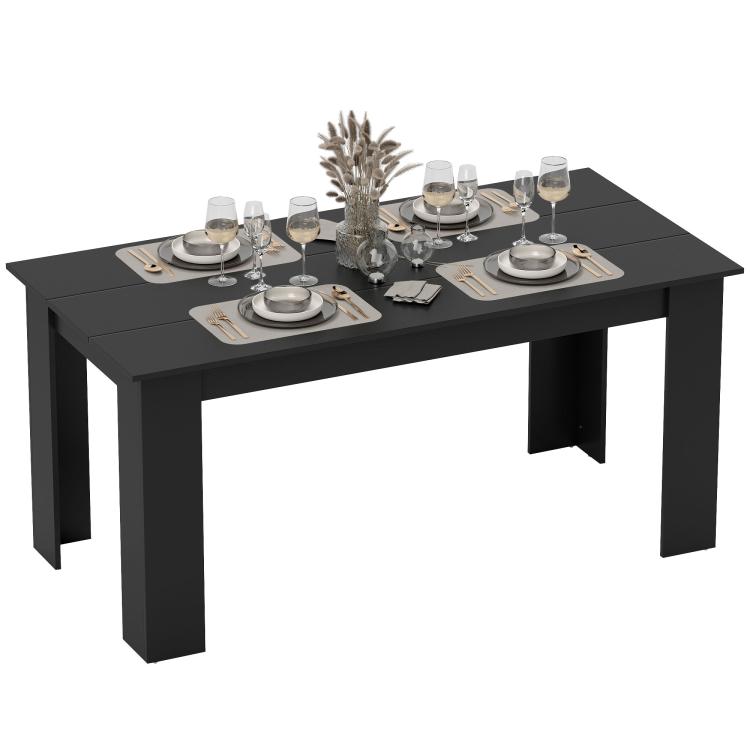 Rectangular black dining table with straight legs and a full dinner place setting