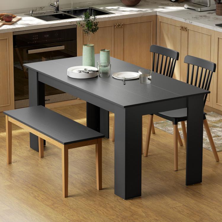 Rectangular dining table with black wood-effect top and four angled legs
