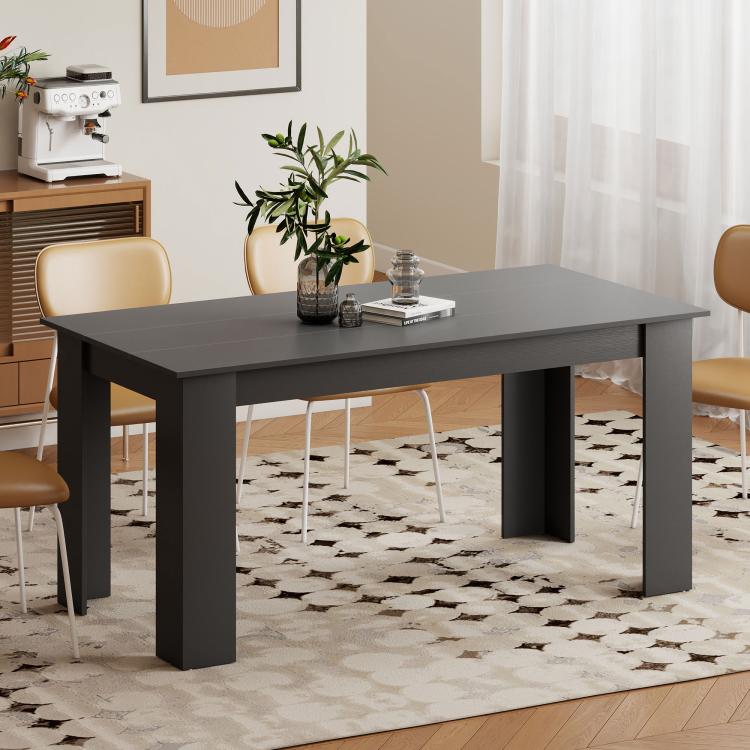 Modern dark rectangular dining table with thick legs and open underside